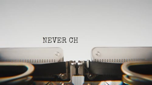 Old mechanical typewriter typing Never Change Who You Are in a close-up view.