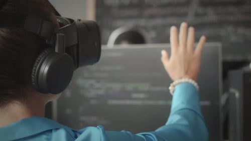 VR Headset User Interacting with Computer Code