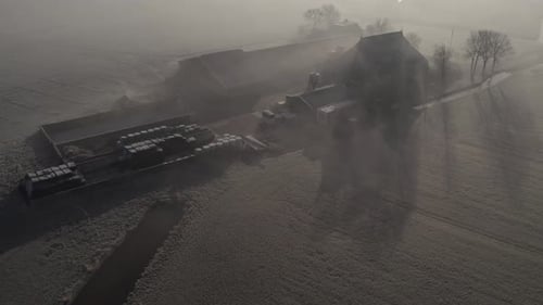 Aerial view of foggy village at sunrise with church, Netherlands.