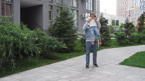 Grandfather Walks with Young Girl in Urban Setting