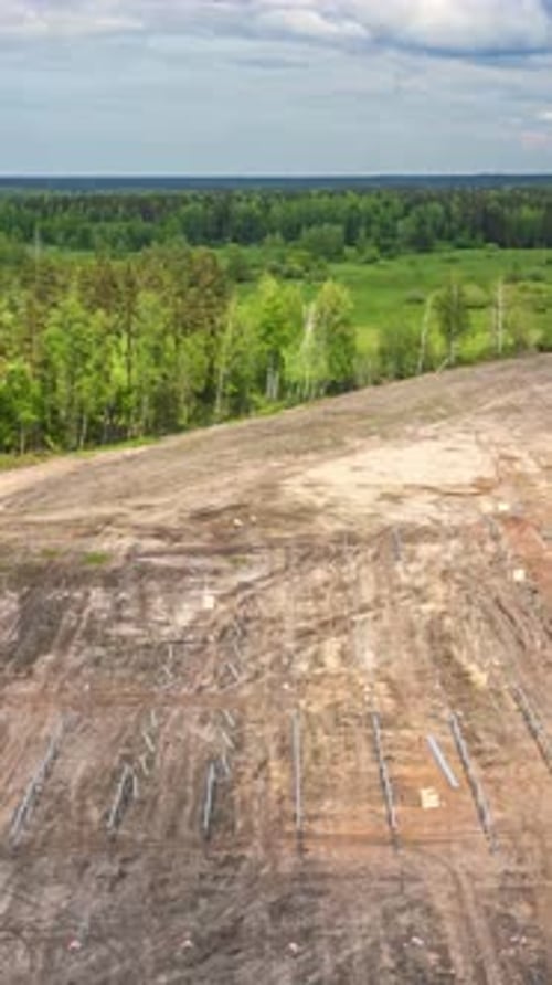 Drone hyperlapse of cleared land with gridlines for development under a blue sky