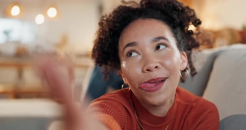 Woman, selfie and face on couch in home with tongue out, excited and post on social media in lounge