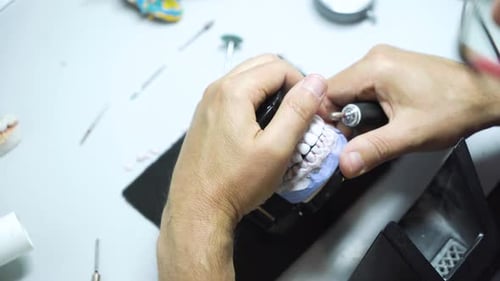 A dental technician makes a denture. laboratory. close-up