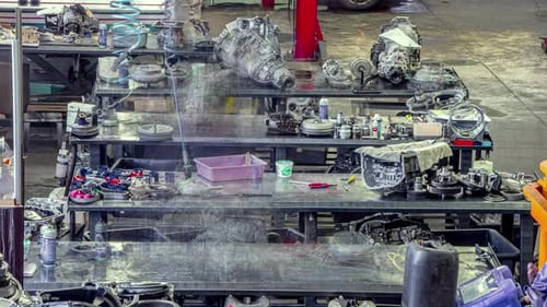 Mechanic's garage with automobile engines being repaired and rebuilt - time lapse