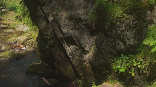 Scenery of Sunlit Rock with Gorge Near Natural Reservoir