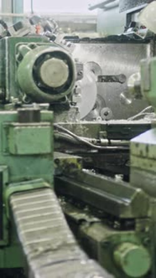 Precision metal shaping in workshop with automated lathe machine
