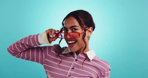 Peace sign, sunglasses and face of woman in studio for outfit, trendy style and cool accessories
