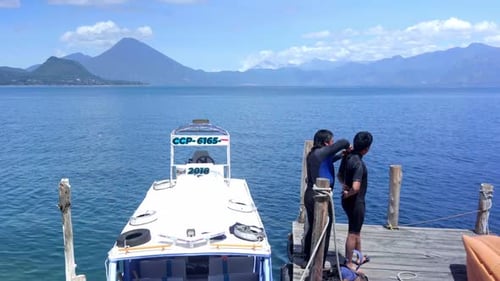 Two men getting ready to scuba diving in a lake