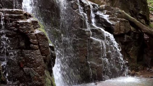 Waterfall in Rocky Mountain. Water Flowing Down in Rocky Path. Stone Water