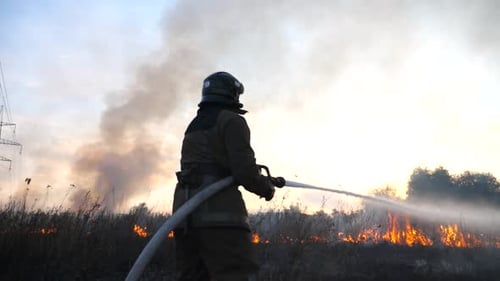 Firefighter Battles Raging Wildfire at Sunset
