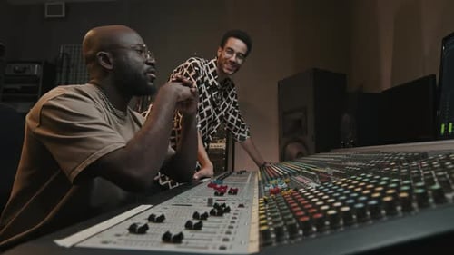 Two Young Men Creating and Recording New Music in Studio