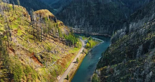 Cyan river flowing quickly among the high mountains.
