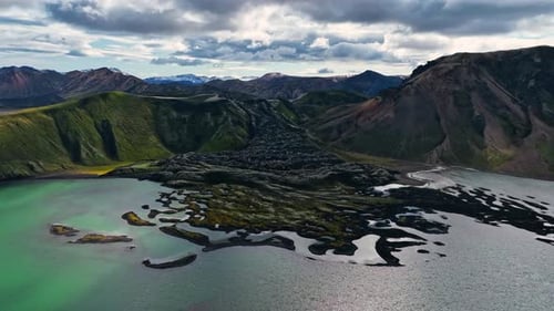 Flying over turquoise lake with old lava in Iceland