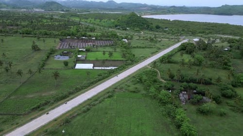 Highangle Shot Capturing Vehicle Movement On Vibrant Coast Road