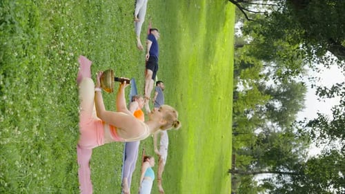 Vertical Screen Woman Playing Singing Bowls During Yoga Meditation in City Park