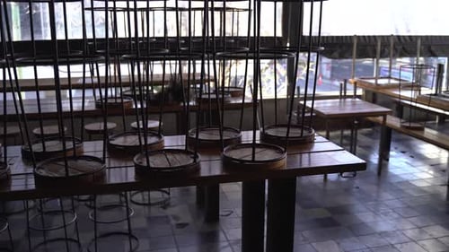 Panning shot of empty bar in closed restaurant during covid-19 pandemic.