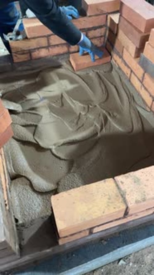 Stove Maker Lays The Foundation Of A Heating Stove.