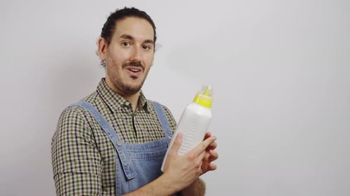 Man Holding Baby Bottle and Gives Thumbs Up