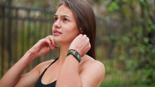 Woman Ties Her Hair Up for Exercise
