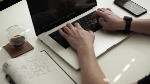 Hands Typing on Laptop in Office Workplace