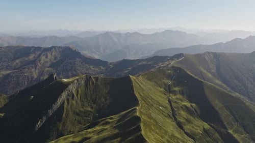 Panoramic View Of Lush Green Mountains Spanning The Horizon In Austria