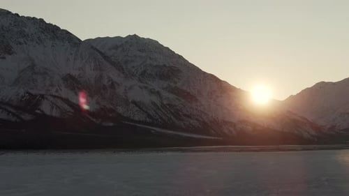 Snowy Mountain And Frozer River At Sunrise. - aerial shot