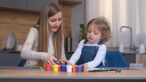 Mother and Child Drawing Together at Table