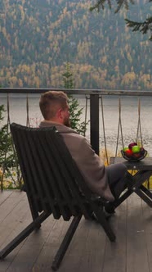 Woman and Man on Terrace at Table with Fruits