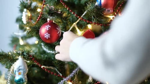 Decorating a Christmas Tree with Red Bows