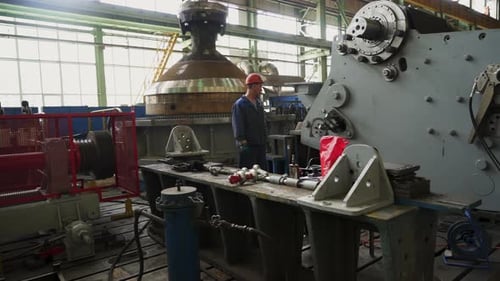Engineer Supervising Machinery Operation in Industrial Plant Stock Clip