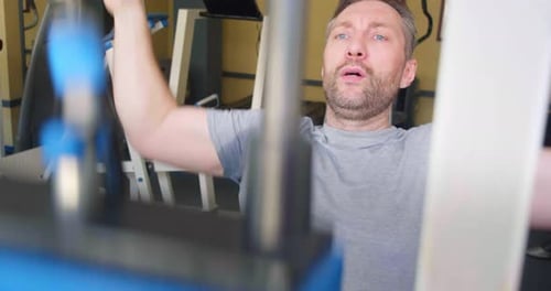 Man Lifting Weights at Gym for Workout