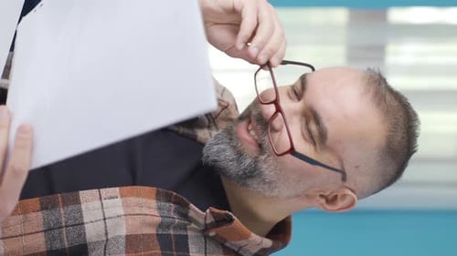 Man Reading Documents Indoors