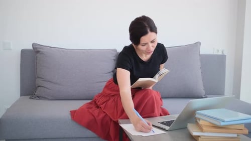 Woman Working From Home on Sofa