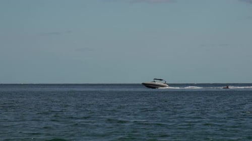 Boat Tubing Water Sports Daytime Leisure on Ocean with Motorboat Pulling Tube for Recreation