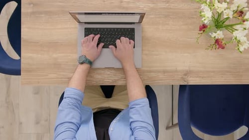 Top Down View Unrecognizable Man in Blue Shirt is Typing on Computer Businessman Working From Home