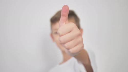 Child Gives Thumbs Up in Close Up