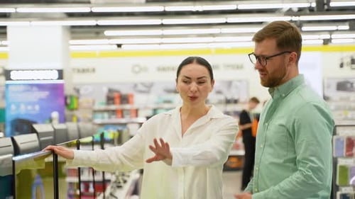 Young Couple at Tech Store Looking for a New Smart TV