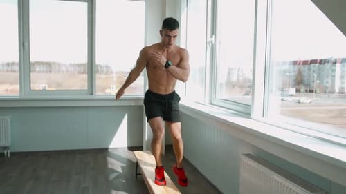 Fit Man Steps Up on Bench for Workout