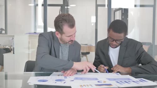 Young People Doing Paperwork in Office