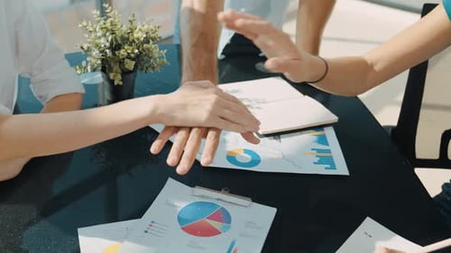 Business Team Stacking Hands Together in Office