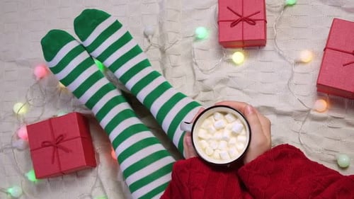 Woman with Cup of Coffee with Marshmallows is Preparing to Christmas Celebration Top View