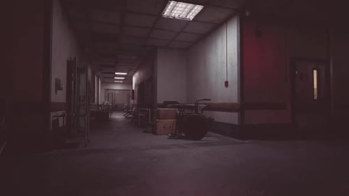 Dark Hallway in Abandoned Building with Scattered Medical Equipment at Night