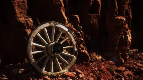 Old Wooden Cart Wheel on Stone Rocks