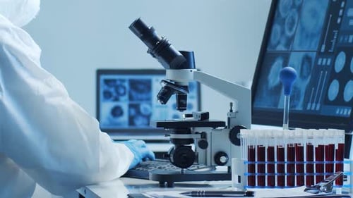 Scientist Analyzing Samples with Microscope in Laboratory