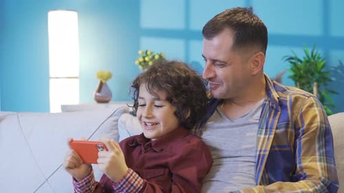 Father and Son Enjoying Mobile Phone Together