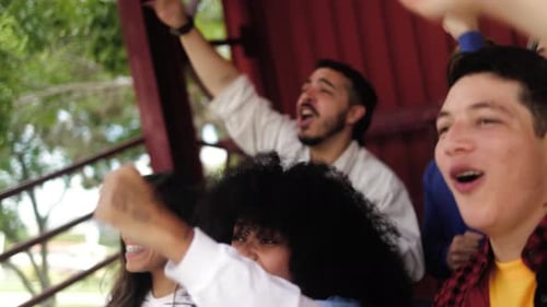 Sport fans support team at football stadium - Crowd of people have fun watching sports champion cup