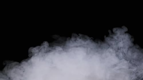 Smoke or Vapor Clouds Rise Up on a Black Background in Slow Motion