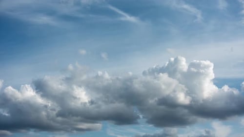 Timelapse of clouds in blue sky.