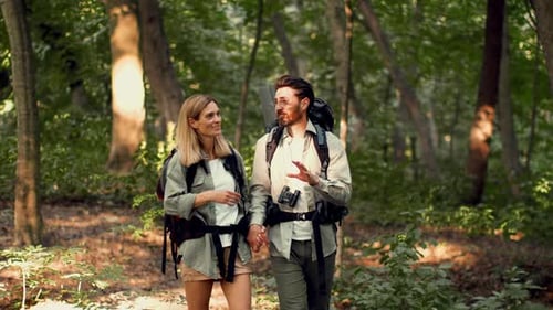 Couple Enjoying a Hike Together in a Forest During Daytime
