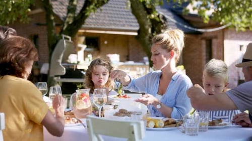 Family Having a Big Garden Party and Feasting Together